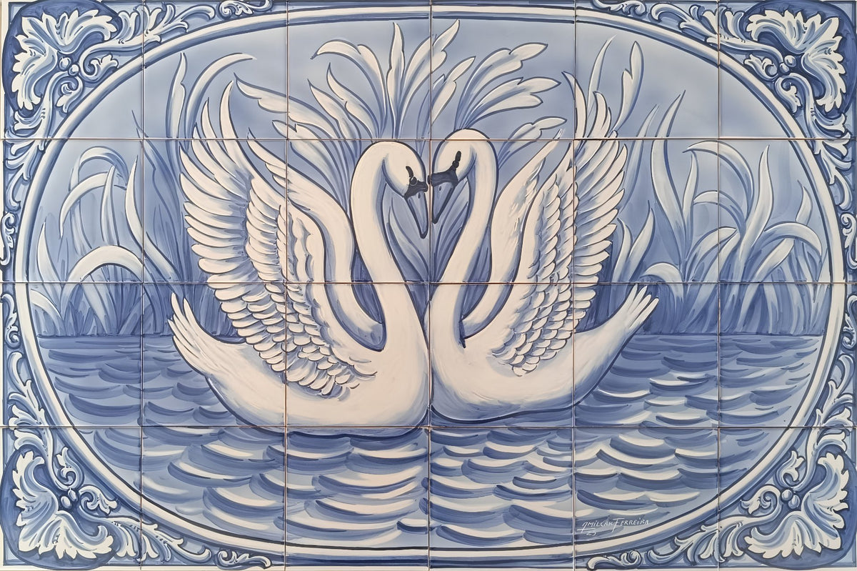 Blue and white Portuguese ceramic tile mural featuring two swans facing each other in water, with ornate decorative borders around the oval composition.