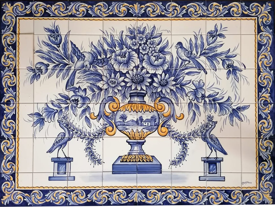 Portuguese tile mural with a blue and yellow flower vase, birds and an ornate floral border.