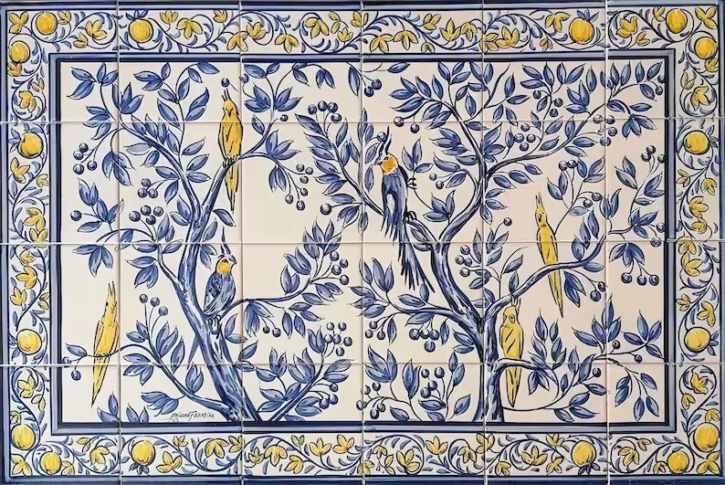 A hand-painted tile mural featuring a Cockatoo bird motif with blue and yellow colors on a white background, surrounded by a floral pattern.