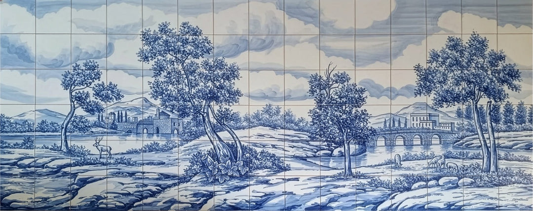 Blue and white hand painted Portuguese tile mural of a landscape with trees, a deer, sheep and buildings. 