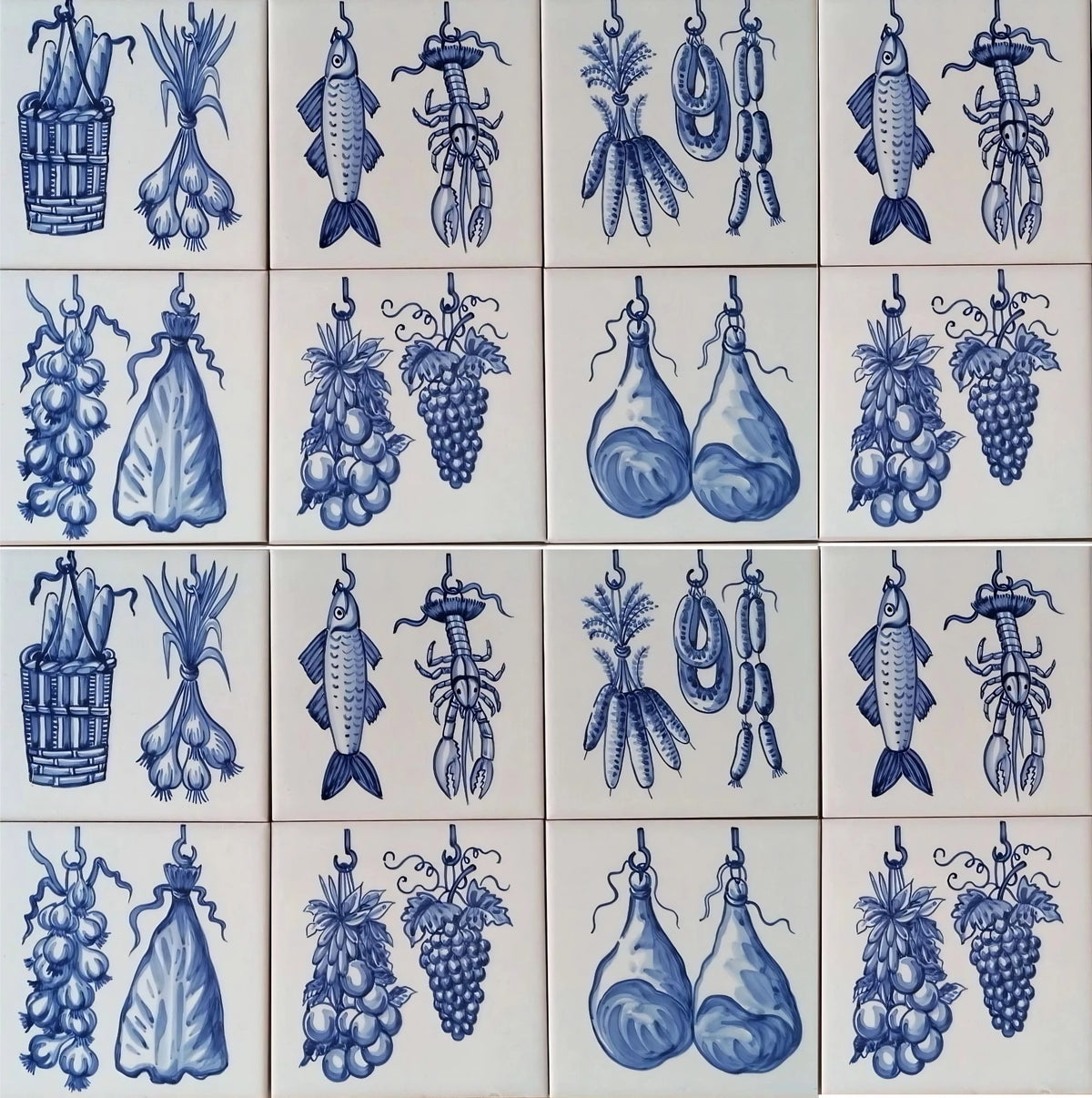 Hand painted kitchen ceramic tiles featuring blue and white illustrations of various fruits and vegetables, including fish, grapes, onions, and pears.
